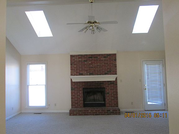 living room with vaulted ceiling and fireplace
