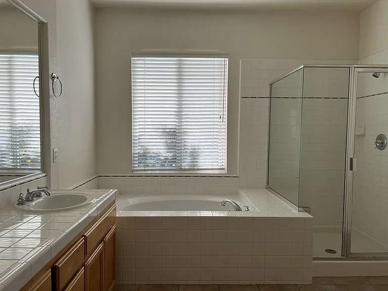 Large bathroom with beautiful accents tiles, and Pfister faucets.