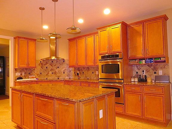 Gourmet eat in kitchen with granite countertops, built in double oven, built in microwave, top of the line appliances and built in $10,000 refrigerator