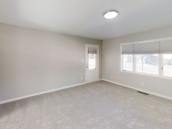 Front door opens to a large spacious living or dining area.