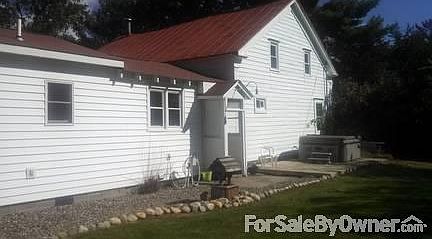 Back of house with convenient hot tub