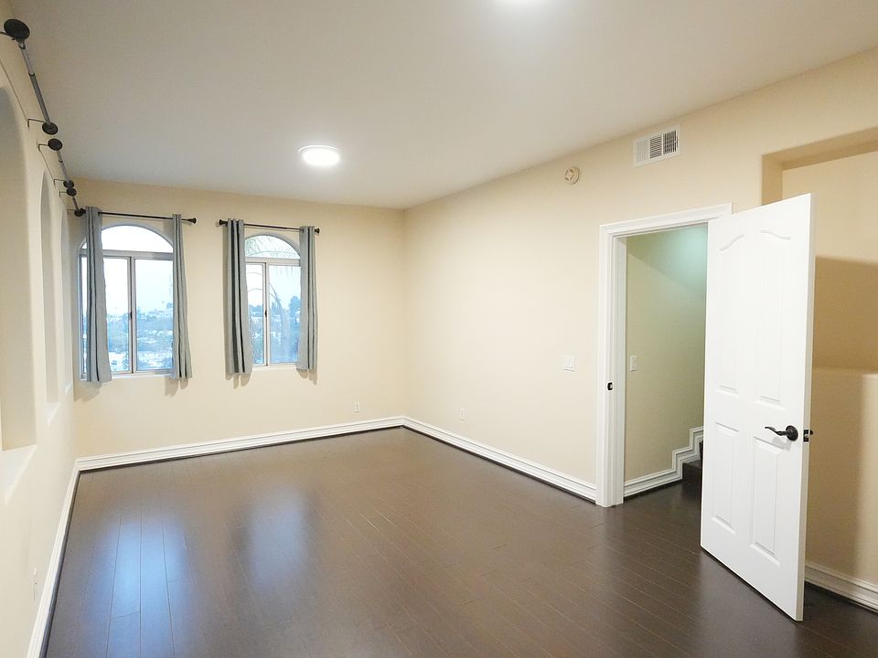 Entrance leads to the front living room with high ceilings. Multiple windows overlooks the entire city landscape.