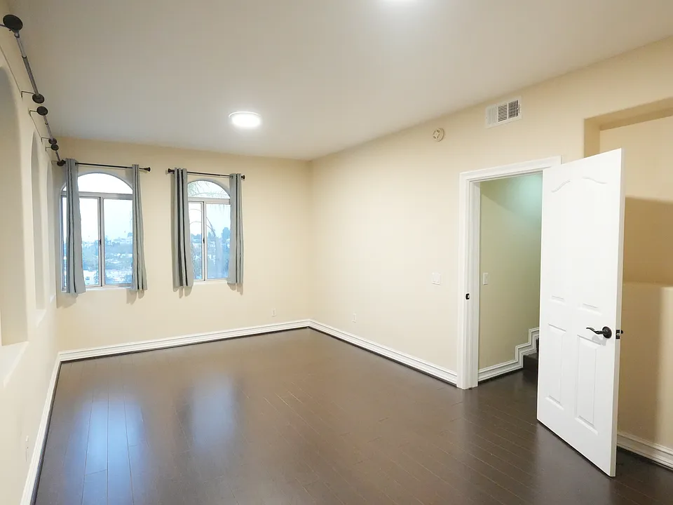 Entrance leads to the front living room with high ceilings. Multiple windows overlooks the entire city landscape.