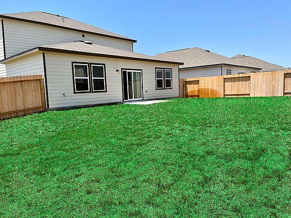 Front-side view of the home and porch from backyard.