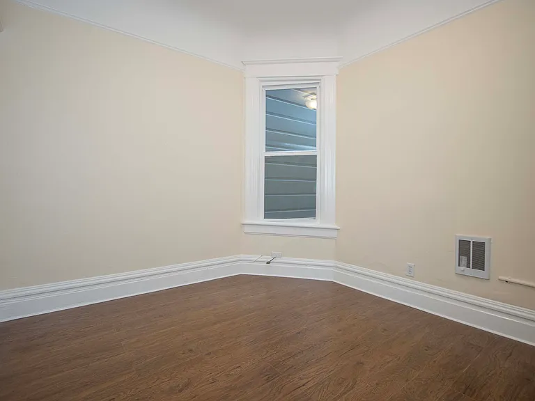 Second bedroom as viewed from its bedroom door; wall heater on lower right