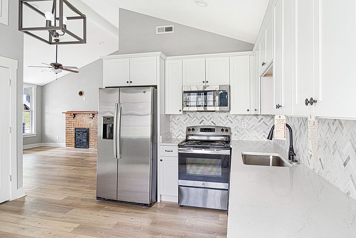 The kitchen, with the living room in the background