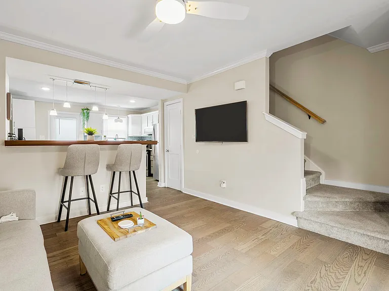 Stairs lead to two bedrooms and the full bath. Half bath is downstairs.