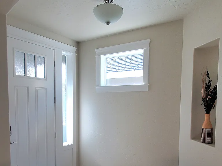 FRONT ENTRANCE WITH CEILING ARCHWAYS.
