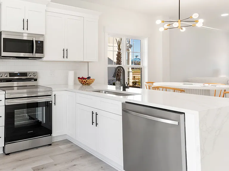 The kitchen has bar seating and measures 15'3" x 10'3".