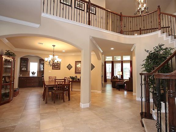 Staircase leads to secondary bedrooms and gameroom/media room upstairs.