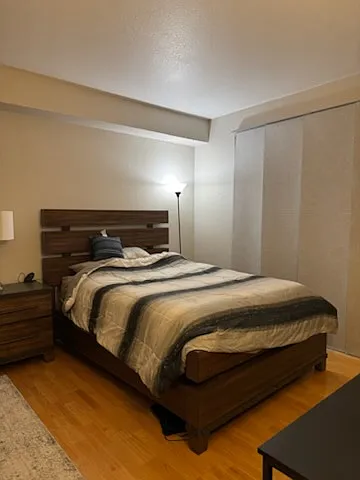A sliding glass door opens to a balcony overlooking the courtyard. Bedroom furniture not included in rental.