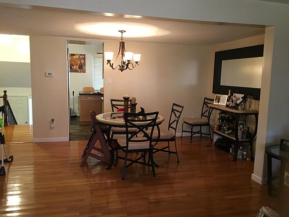 Dining room off of kitchen with hardwood floors.