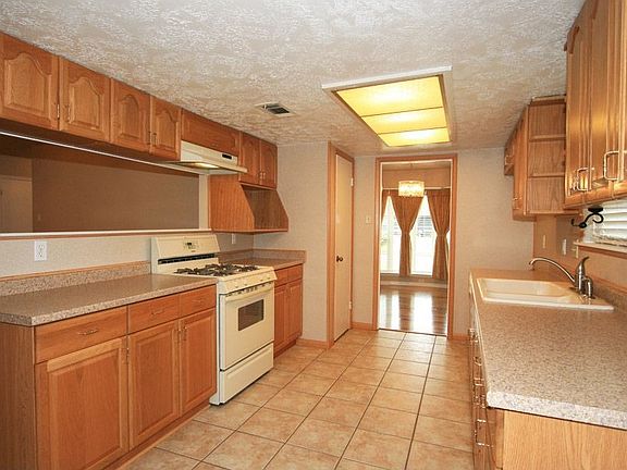 Kitchen showing pass through to family room. Could be a breakfast bar.