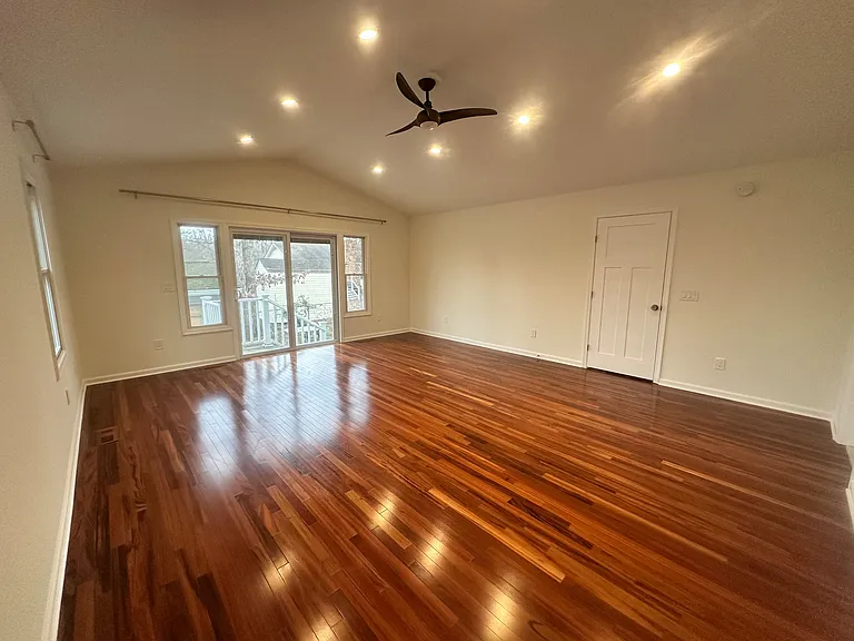 Spacious primary suite with cathedral ceiling. Features two spacious closets, a sliding glass door leading to the backyard. The door also features built in blinds for convenience and privacy. There is also a primary bathroom attached.