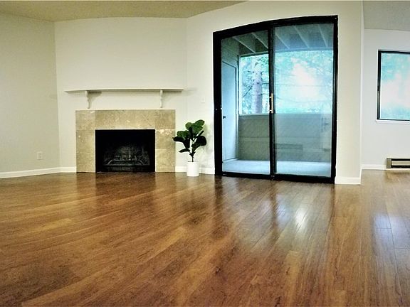 Beautiful hardwood floors, wood burning fireplace, and deck that opens to the greenbelt