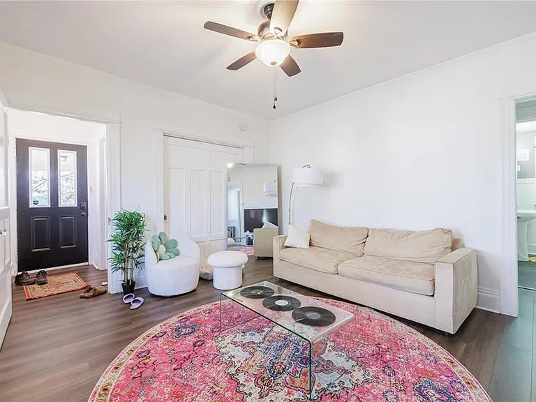 Living room showing first bedroom behind sliding door