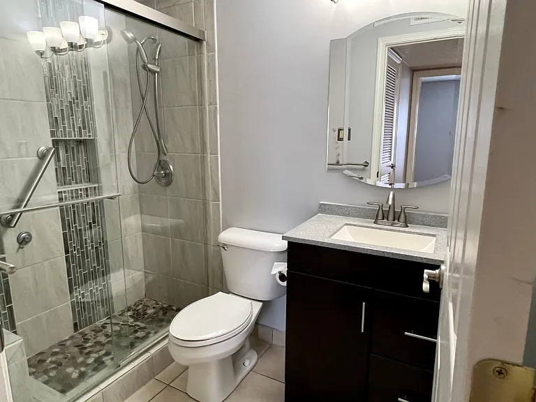 Updated bath with walk-in shower and waterfall tile