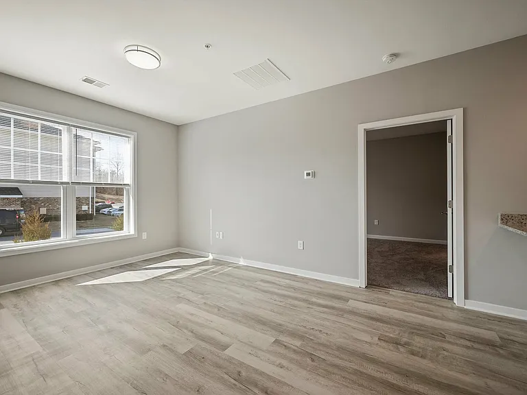 Step into a beautifully lit living area with contemporary design elements.
