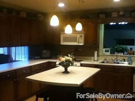 Kitchen
						:
						Beautiful cabinets w/built-in desk & large island that provides seating for 4.