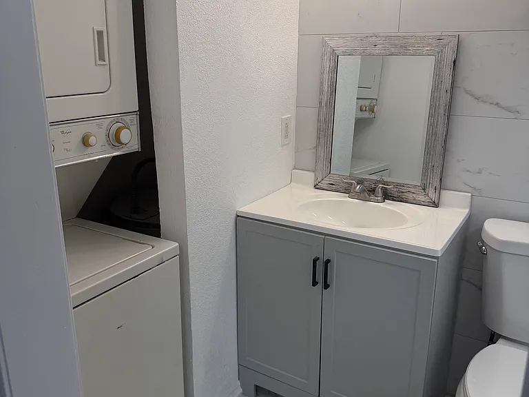 Bathroom with stackable washer and dryer.