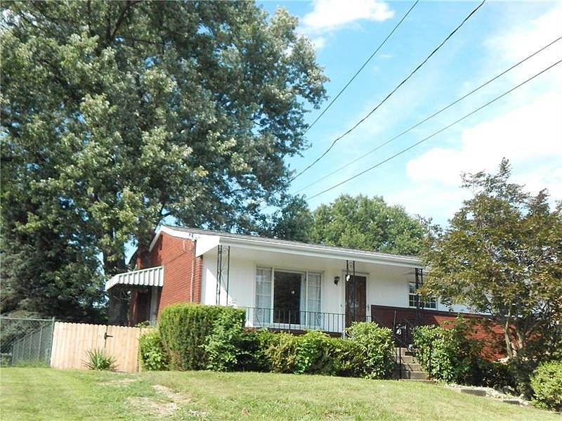 BRICK RANCH WITH COVERED FRONT PORCH.