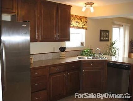 Kitchen : Cabinets swing around the corner for a large bar area. Look at all the space!