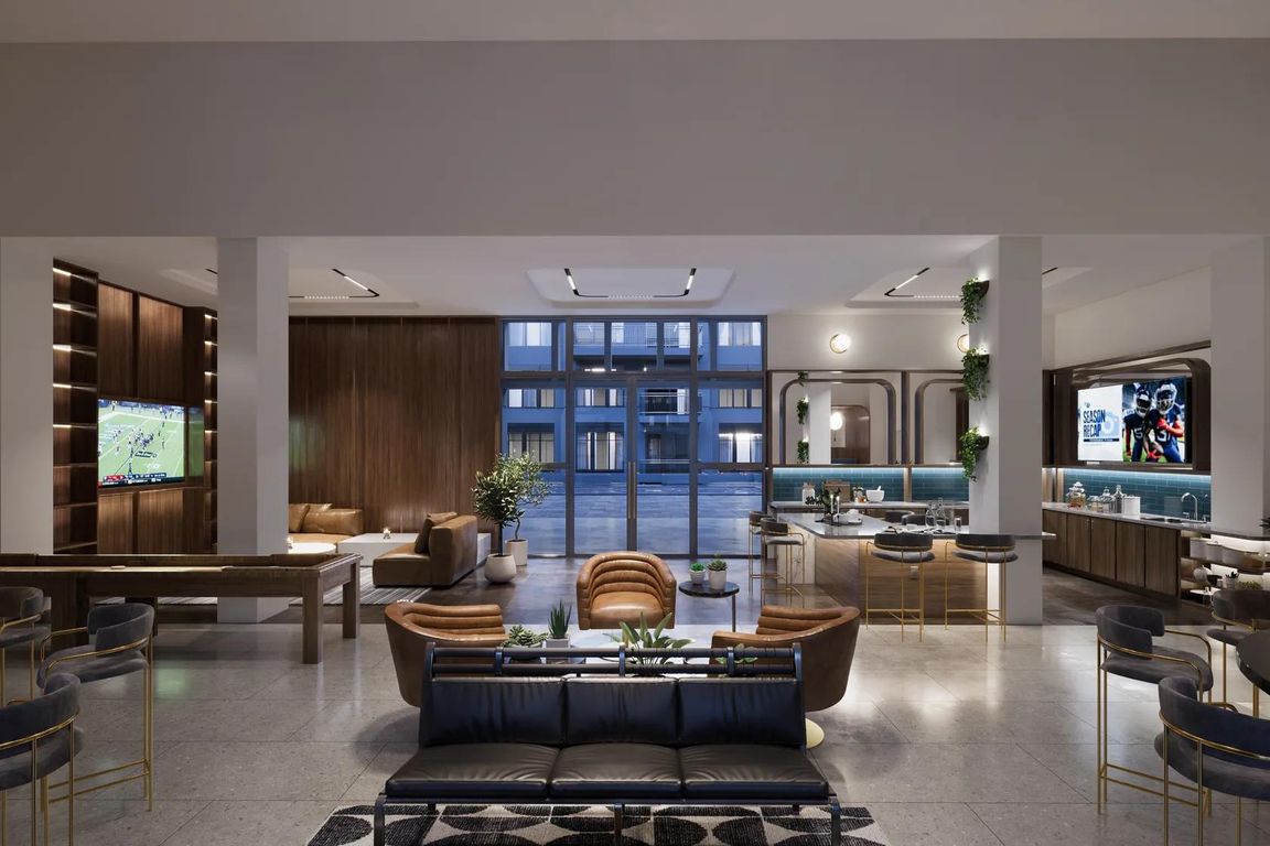 Expansive clubroom with gathering space, demonstration kitchen, and shuffleboard.