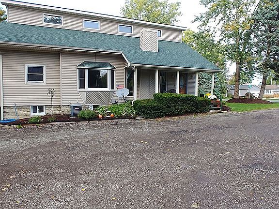 Side of home with front porchandtonsofparking