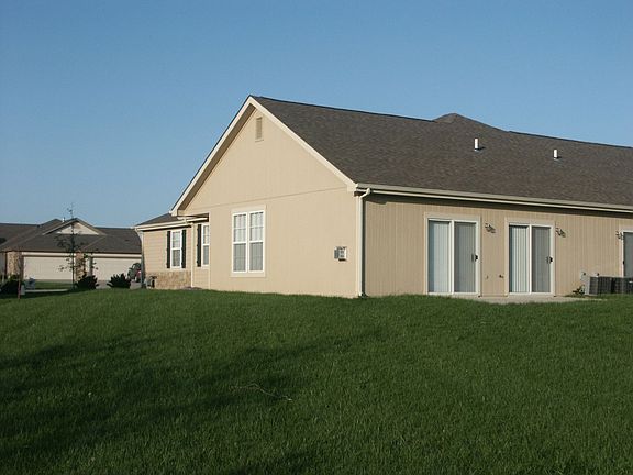 House sits on large lot with several trees. 