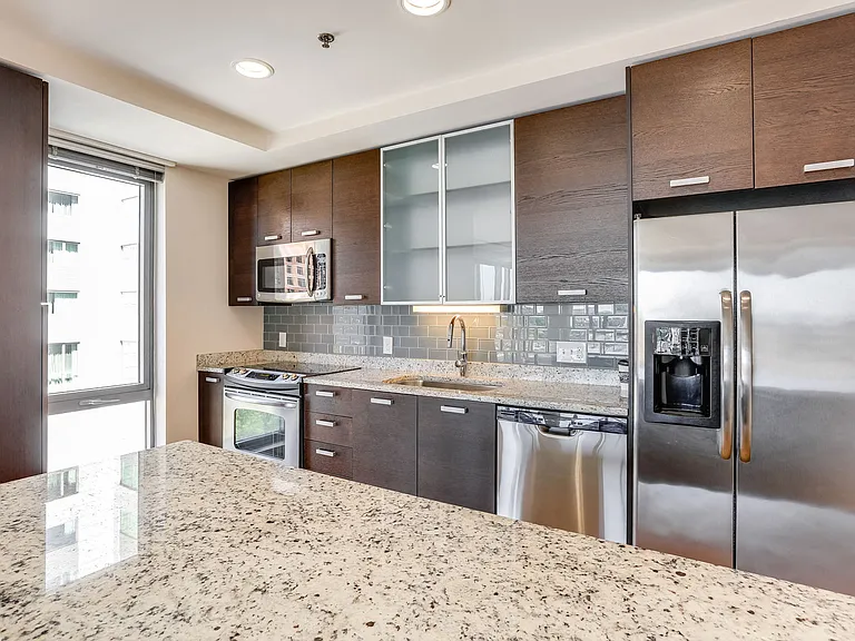 Side-by-side refrigerator and thru-the-door ice water dispenser