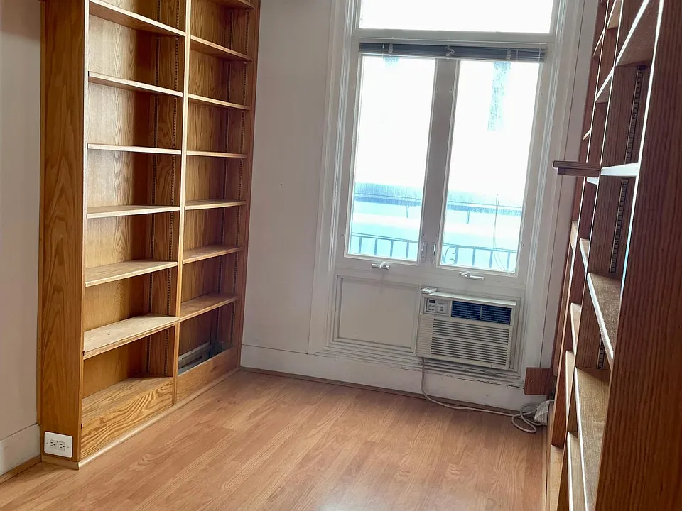 Den/library/office space with custom wooden shelving