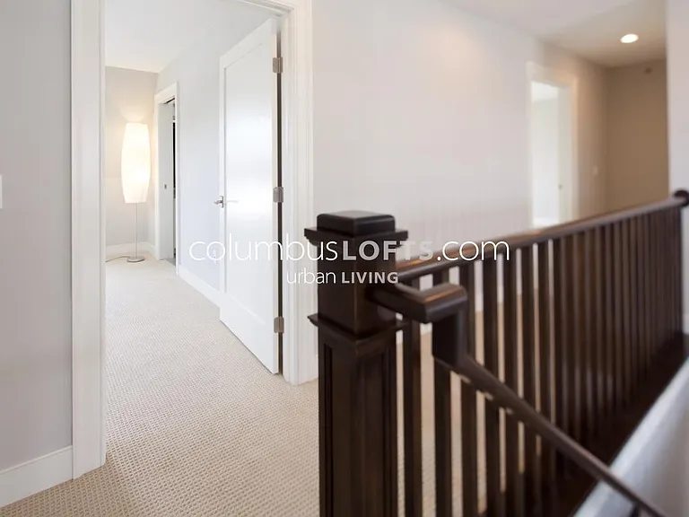 hallway atop stairs to upper level, which overlooks great room below and has doors into 2 separate bedrooms with a "Jack-and-Jill" full bathroom connecting them in between.