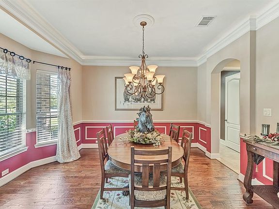 grand entrance with porcelain tile flooring, two story ceiling, and dramatic curved staircase
