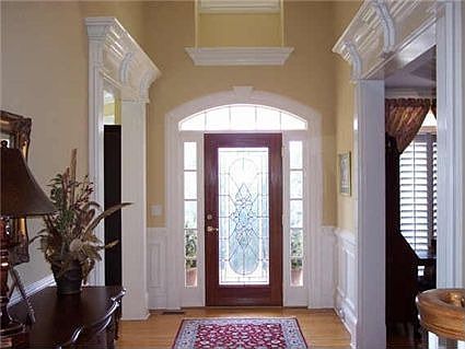 Mill work abounds in this beautiful 2 story foyer.