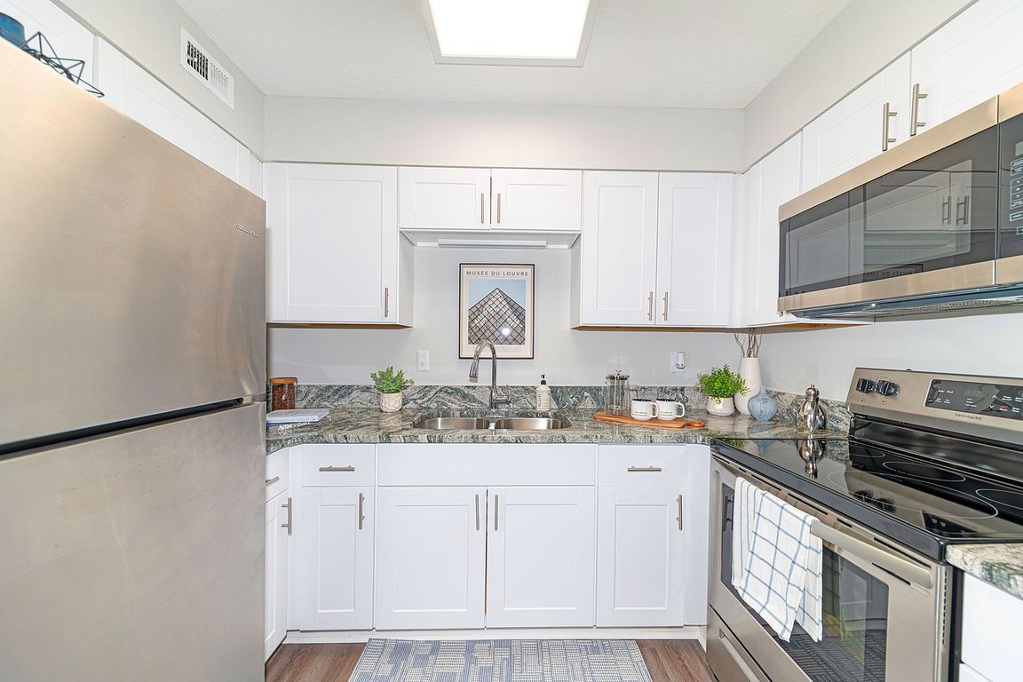 Kitchen with granite counters, stainless appliances, and modern cabinetry