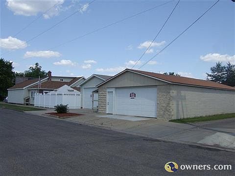 Two large garages and back side of house
