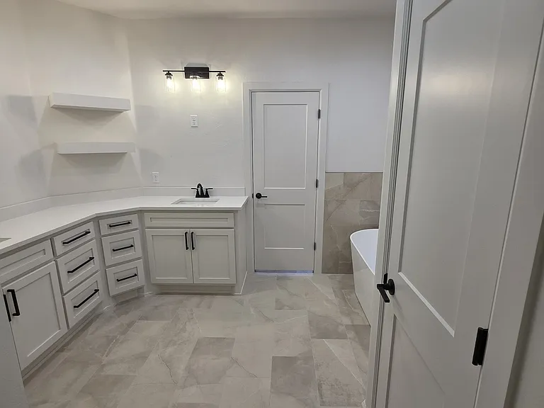 A double vanity with drawer and cabinet space offers plenty of room for couples