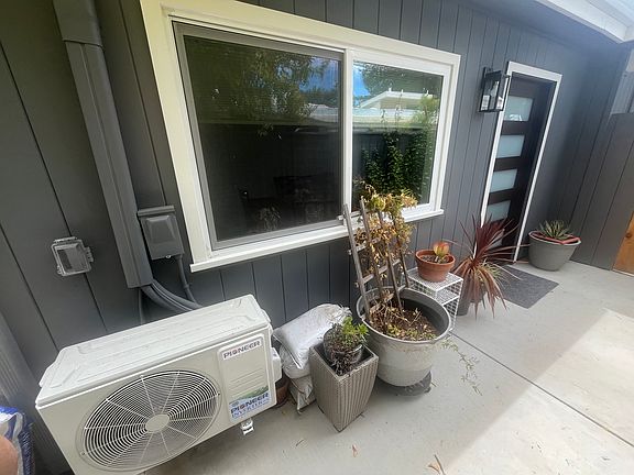 Walkway to the ADU front door showing second window and dedicated mini-split AC unit