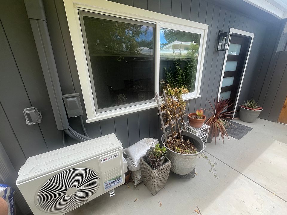 Walkway to the ADU front door showing second window and dedicated mini-split AC unit