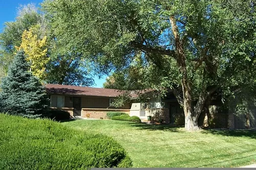 Park-like front yard with impressive, large, mature trees. Lawn mowing is included. - 12413 W 12th Pl