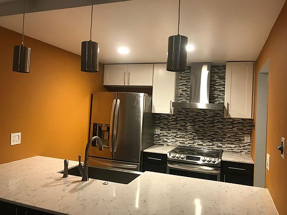 Kitchen has top of the line appliances, including an electric stove and and quiet dishwasher