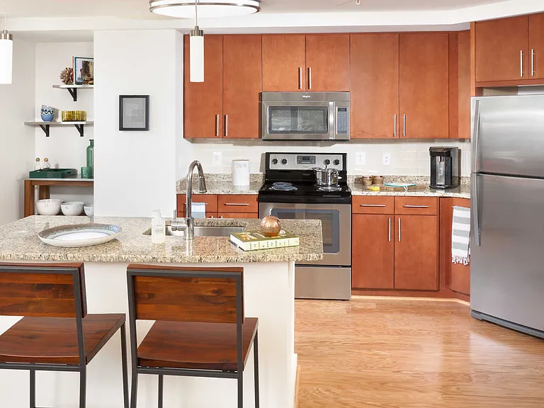 Island Kitchen with Stainless Steel Appliances, Cherrywood Cabinets and Hard Surface Flooring