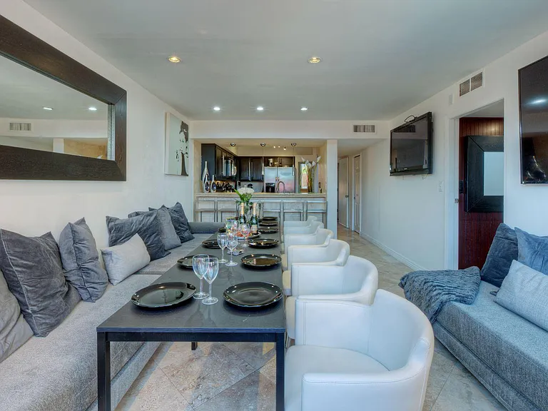 Entertaining Modern Living - Dining - Bar Lounge with long table for larger families/friends including a 70 inch 4k Smart TV next to the outdoor SPA patio.