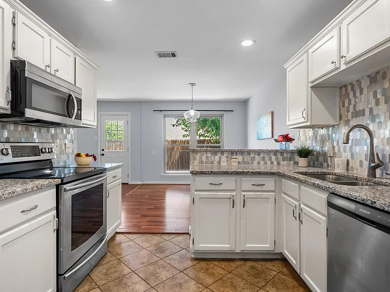 The kitchen has stainless steel appliances.