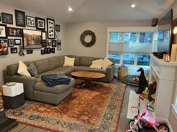 Large open living room with big windows and lots of natural light with top down/bottom up shades