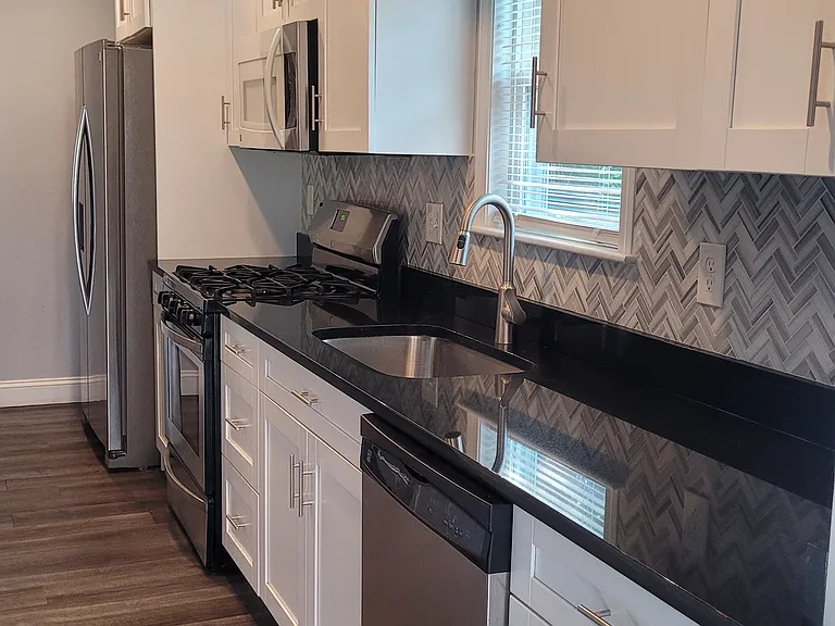 White cabinetry and gorgeous black granite counter tops