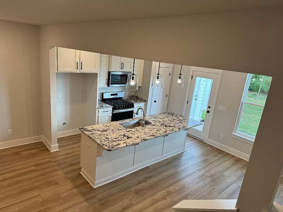 The Kitchen has Beautiful Granite Countertops and Stainless Steel Appliances. Refrigerator to come.