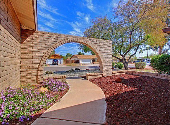 This archway and courtyard create a welcoming entrance to the home!