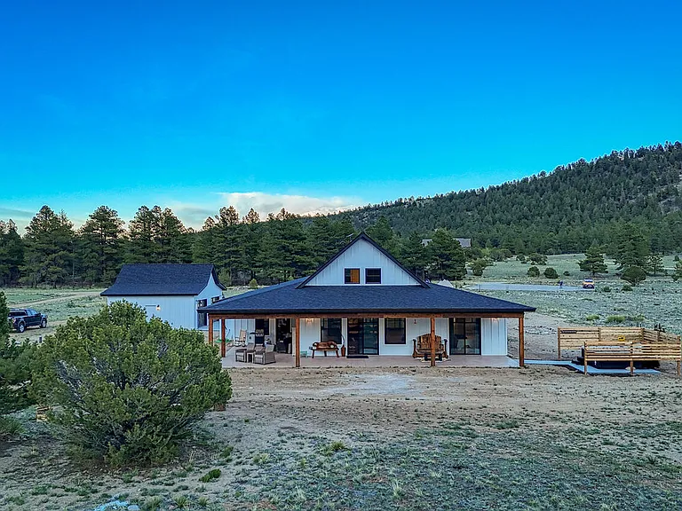 The back of the lodge is a huge entertaining space. With a large wrap around porch, a bbq grill, 4 seating areas and of course, that fabulous hot tub and fire pit.