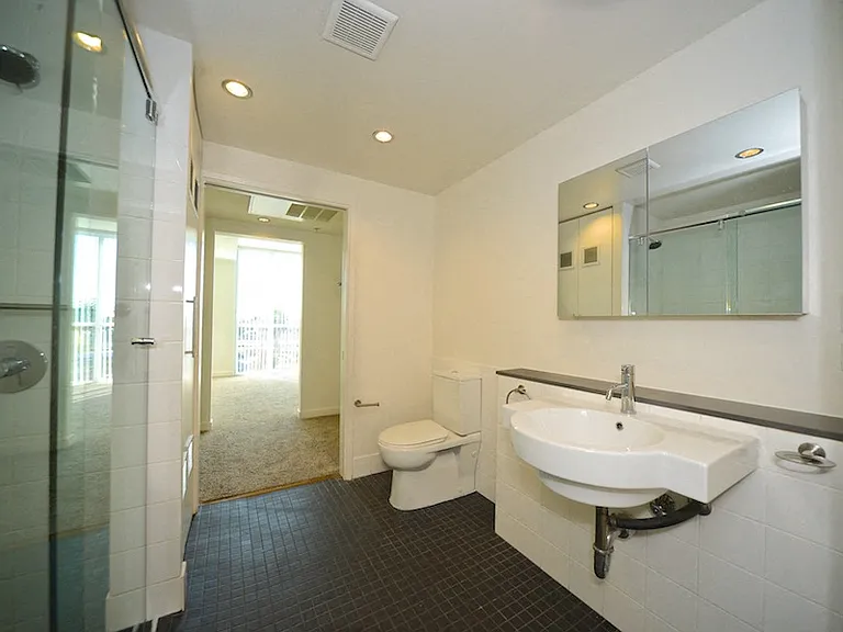 Sink and toilet in master bathroom at 12th Street Lofts in National City, California.